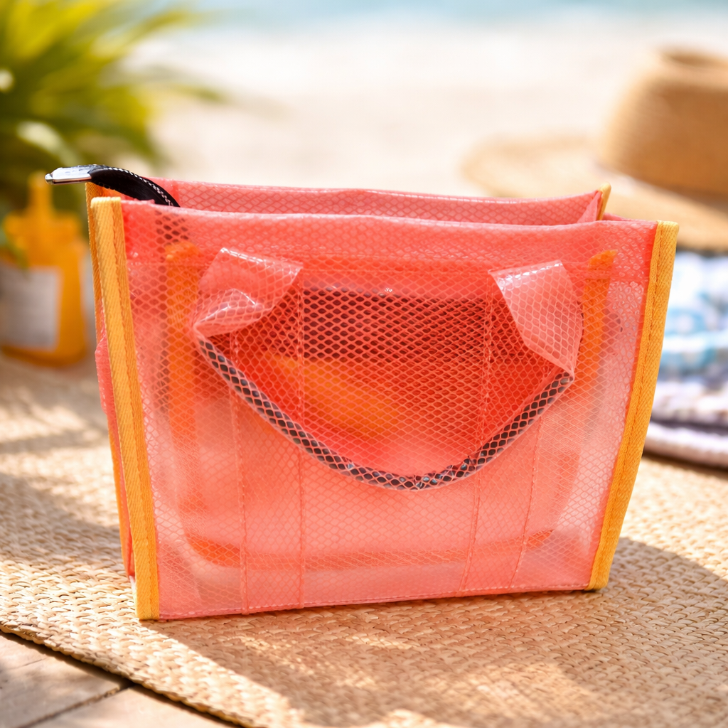 Pink mesh bag with wooden frame on a woven surface with blurred background
