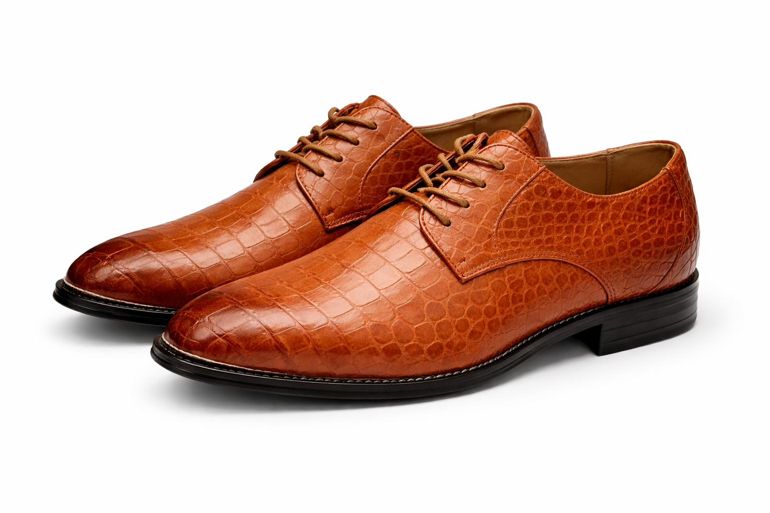Pair of brown leather shoes with a textured finish on a white background