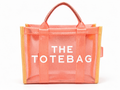 Coral tote bag with 'THE TOTEBAG' text on a white background
