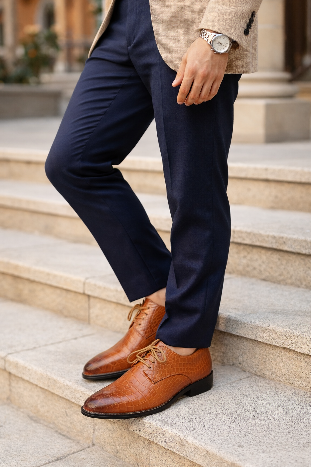 Navy pants and brown shoes on a person standing on steps.